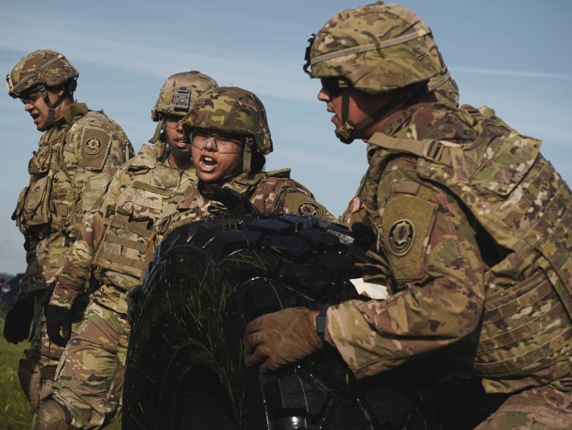 U.S. Soldiers, assigned to the Regimental Support Squadron, 2d Cavalry Regiment, push tire to finish line during the Commander Cup event in Vilseck, Germany, June 19, 2020. The event consisted of a 6km ruck march, 100 pull ups, 100 push ups, the water can and sandbag carry, tire flips, the sled drag and ending with the tug of war. (U.S. Army photo by Sgt. LaShic Patterson)