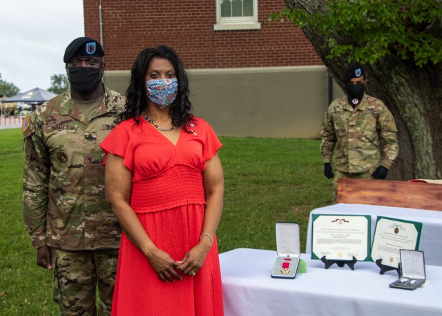 Command Sgt. Maj. Bernard P. Smalls Sr., outgoing senior enlisted advisor, 1st Theater Sustainment Command, and his wife, Mrs. Veronica Smalls, receive awards for their service to the 1st TSC, July 28, 2020 at Fort Knox, Kentucky. (U.S. Army photo...