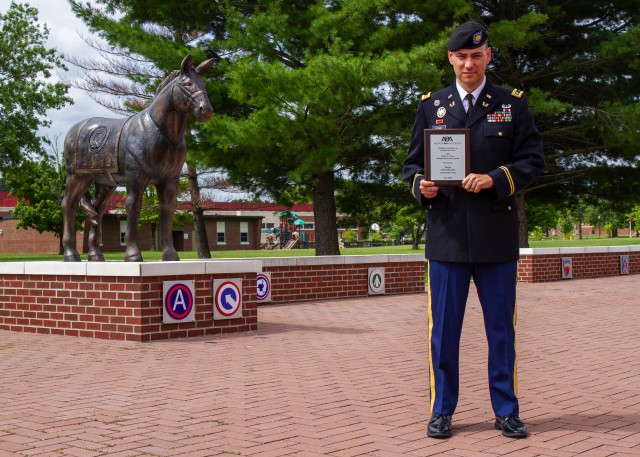 Maj. Adam Kama, deputy judge advocate, 1st Theater Sustainment Command, stands in front of Fowler Hall as the recipient of the Keithe E. Nelson Distinguished Service Award at Ft. Knox, Kentucky, July 28, 2020. According to the American Bar...