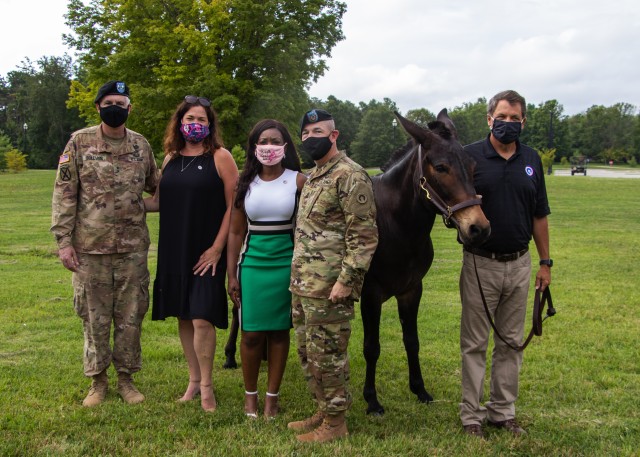 (L to R) Maj. Gen. John P. Sullivan, commanding general of 1st Theater Sustainment Command, alongside his wife, Mrs. Jennifer Sullivan, and Command Sgt. Maj. Michael J. Perry III, senior enlisted advisor, 1st TSC, and his wife Mrs. Razell Perry, pose with the 1st TSC mascot, Sgt. Blackjack, at Fort Knox, Kentucky, July 28, 2020. (U.S. Army photo by Spc. Zoran Raduka, 1st TSC Public Affairs)