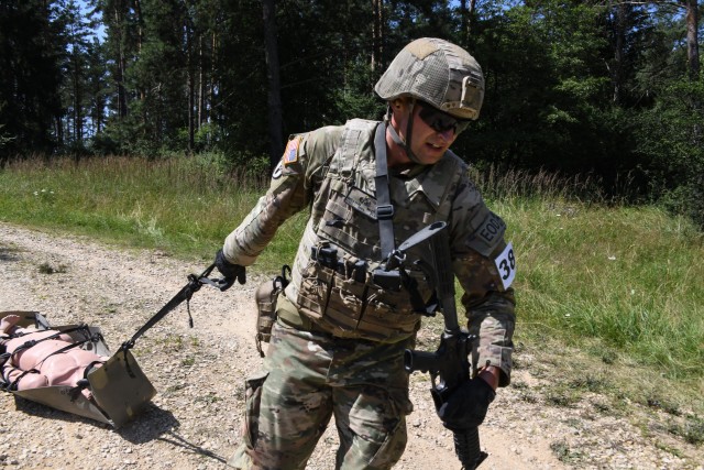 U.S. Army Staff Sgt. William McLain, explosive ordnance disposal specialist, 18th Sustainment Brigade, pulls a Skedco during the U.S. Army Europe European Best Warrior Competition at U.S. Army Garrison Hohenfels Training Area, Germany, July 29,...