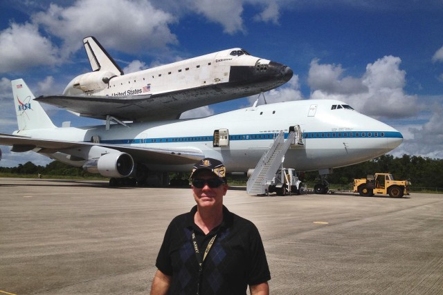 U.S. Army Reserve Lt. Col. Pat Lis stands in front of a Boeing 747-100 National Aeronautics and Space Administration Shuttle Carrier Aircraft that is carrying the Space Shuttle Endeavor at the Kennedy Space Center in Florida. Lis credits the U.S....