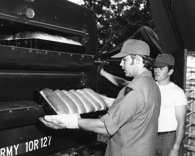 Members of the bakery section of the 312th General Supply Company, Des Moines and Ames, Iowa, Iowa Army National Guard, prepare bread at a field training site July 2, 1974. The 312th was under the 103rd Support Brigade and visited Camp McCoy for...