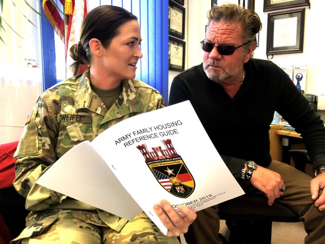 Staff Sgt. Kylie Zweifel, Baumholder Army Family Housing building coordinator, left, goes over some finer points of the Army Family Housing Reference Guide with Jim Gillis, Baumholder Housing deputy director.