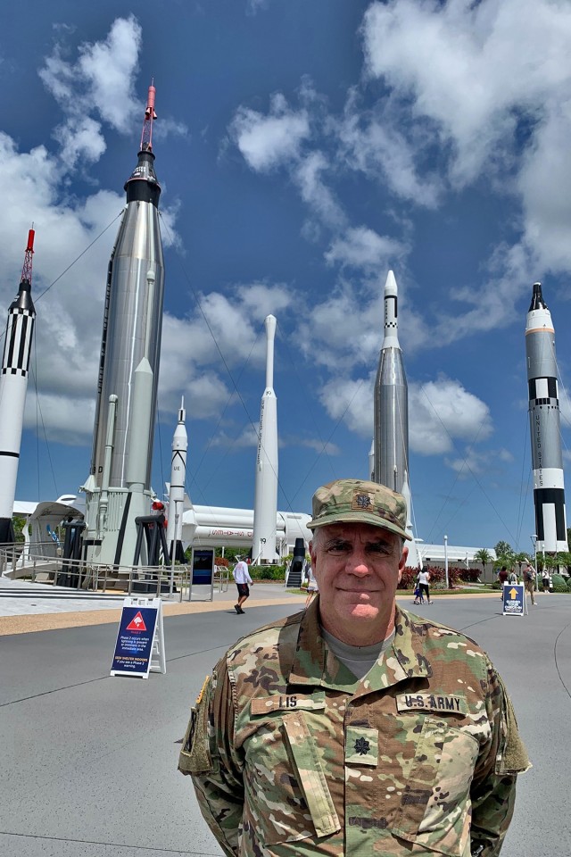 U.S. Army Reserve Lt. Col. Pat Lis stands in front of the “Rocket Garden” attraction at the Kennedy Space Center Visitor Complex in Florida. The Rocket Garden represents rockets from NASA’s Mercury, Gemini and Apollo programs including; the...