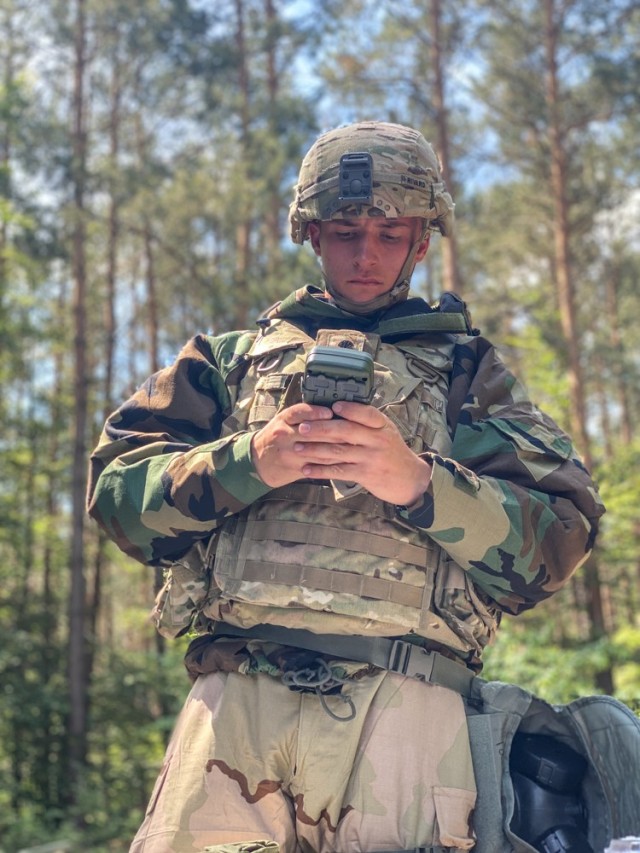 RHINE ORDNANCE BARRACKS, Germany - Spc. Justin Rivard, a team chief assigned to Bravo Battery, 5th Battalion, 4th Air Defense Artillery Regiment at Ansbach, Germany assembles a Radio and Defense Advanced GPS Receiver (DAGR) on Rhine Ordnance...