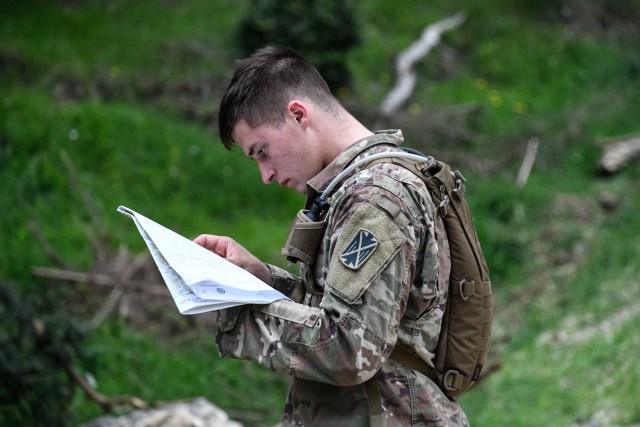 U.S. Army Spc. Justin Rivard, 10th Army Air and Missile Defense Command, plots his next grid point on the land navigation course during the U.S. Army Europe European Best Warrior Competition at U.S. Army Garrison Hohenfels Training Area, Germany,...