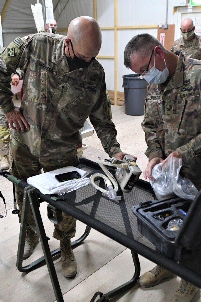 U.S. Army Col. Jon DuBose (right), brigade surgeon for the 30th Armored Brigade Combat Team, Task Force Spartan, assembles a ventilator for Brig. Gen. Thomas Spencer (left), deputy commanding general for support for Task Force Spartan Shield and...