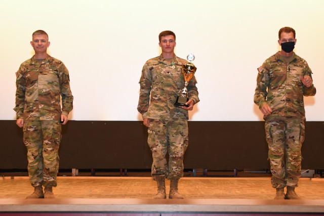 U.S. Army Col. Timothy MacDonald(left), 18th Military Police Brigade, Spc. Justin Rivard(center), air and missile defense crewmember, 10th Air and Missile Defense Command, and  Command Sgt. Maj. Robert V. Abernethy(right), senior enlisted advisor...