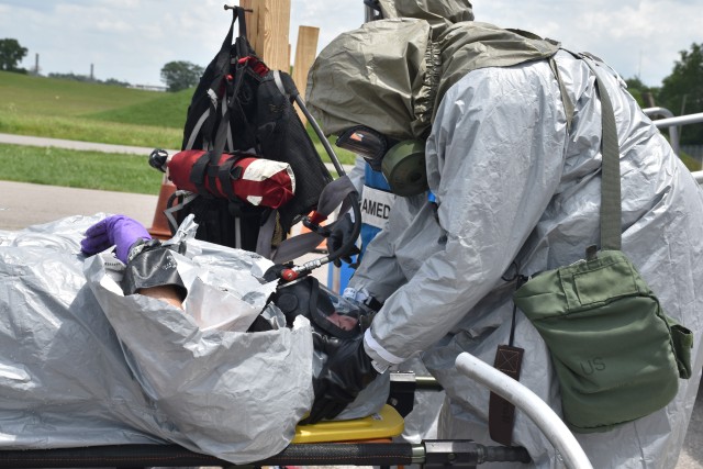 A Blue Grass Army Depot medic and a Blue Grass Chemical Activity toxic materials handler respond to a mock accident and injury during the pre-operational survey.