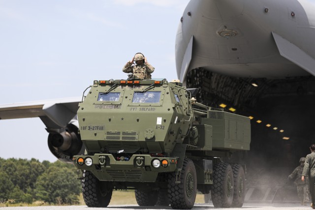 Crewmembers assigned to 3rd Battalion, 27th Field Artillery Regiment (HIMARS), unload a M142 High Mobility Artillery Rocket System, from a C-17 Globemaster III, en route to a simulated firing mission, at Fort A.P. Hill Landing Zone, Virginia, July...