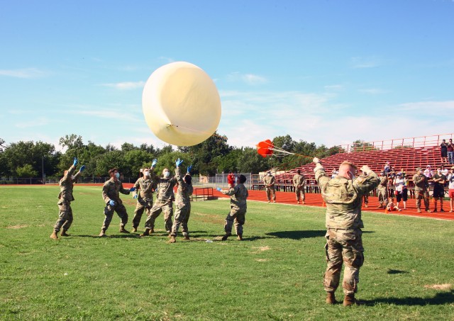 Air Defense Artillery Soldiers from C Battery, 5th Battalion, 5th Air Defense Artillery at Fort Sill, Oklahoma, attempt to launch a helium balloon on a windy morning July 31, 2020 at the Dr. Charles E. Green Field next to Lawton High School. The...