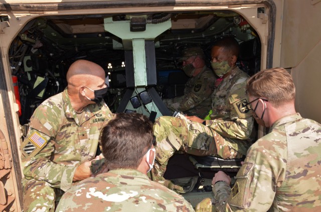 Army leaders inspect the inside of a modified Bradley Fighting Vehicle, known as a Mission Enabling Technologies-Demonstrator, before an exercise at Fort Carson, Colo. Soldiers from the 4th Infantry Division conducted live-fire exercises during testing of the MET-D and robotic combat vehicle, or RCV. Brig. Gen. Richard Coffman, director of the Next Generation Combat Vehicle-Cross Functional Team, shared his thoughts on the progress of the testing Aug. 6, 2020.