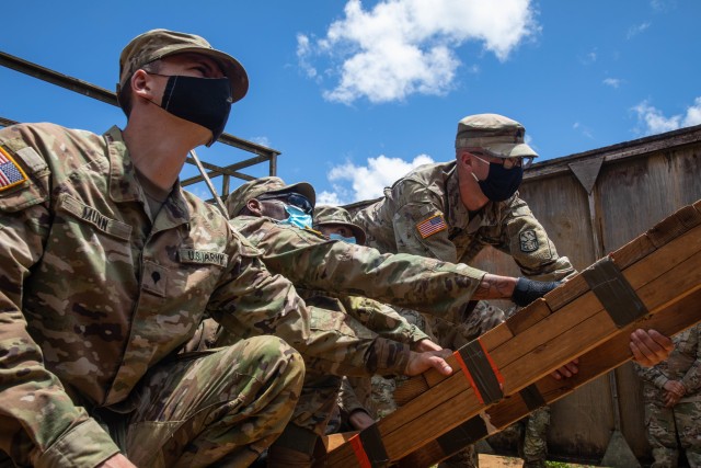 Soldiers from the 94th Army Air and Missile Defense Command work together to maneuver through the Leader Reaction Course as part of the 94th AAMDC Best Warrior Competition on July 29, 2020, at Schofield Barracks, Hawaii.