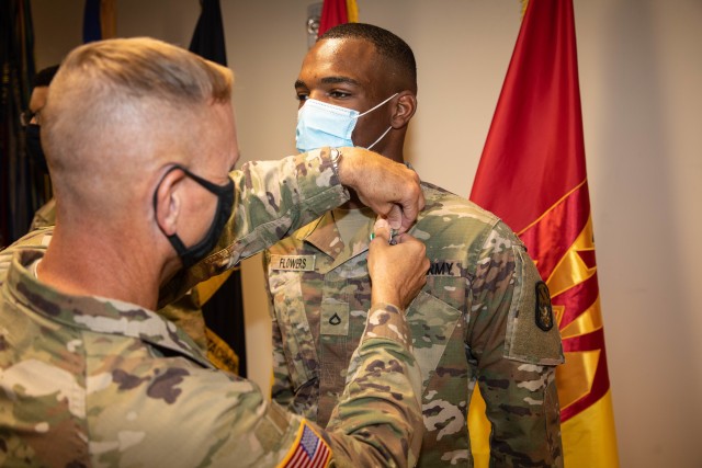 Brig. Gen. Mark A. Holler, the Commander of the 94th Army Air and Missile Defense Command pins the Army Commendation Medal on Pfc. Vernon Flowers, an Air Defense Enhanced Early Warning System Operator assigned to the 14th Missile Defense Battery, 94th AAMDC, for winning the 94th AAMDC Soldier of the Year competition. Flowers is set to compete at the U.S. Army Pacific Soldier of the Year competition in late August.