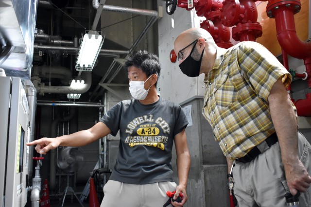 Makoto Akabame, left, a mechanical system inspector for the Directorate of Public Works, U.S. Army Garrison Japan, and David Crespo, chief of the directorate’s mechanical and sanitation branch, look at a monitor while overseeing an air...