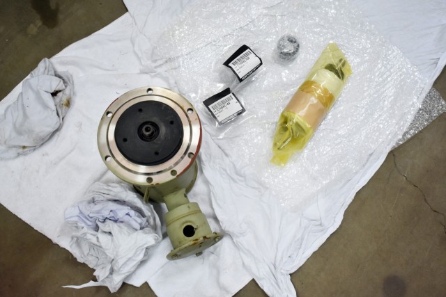 A broken chemical feed pump and replacement parts stand ready for an air conditioning repair job in Building 1050 at Camp Zama, Japan, Aug. 6.