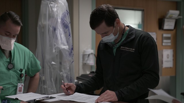 Army Maj. Michal Sobieszczyk, staff physician, Interventional Pulmonology and Critical Care Medicine, reviews paperwork in a COVID-19 intensive care unit at Brooke Army Medical Center, Joint Base San Antonio-Fort Sam Houston, Texas, July 17, 2020. (U.S. Army photo by James Camillocci)