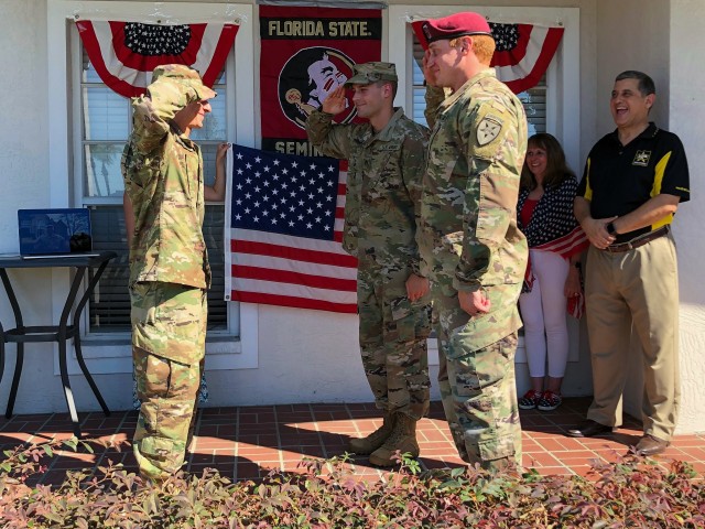 U.S. Army Reserve 2nd Lt. Curtis Rahman returns a salute from his brothers Staff Sgt.Craig Rahman and Staff Sgt. Clark Rahman during his virtual commissioning ceremony held at his parent's home in Florida, May 2, 2020. 2nd Lt. Rahman is a cyber...