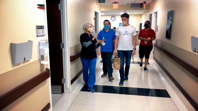 Winn Army Community Hospital nurse, Pam Risner, (Left) accompanied by Winn FRSA Richele Martinez (Right), escort Chris Larson and Mathiew Tackitt through Winn ACH as Tackitt and Larson deliver Facemask and mask extenders to healthcare providers on...