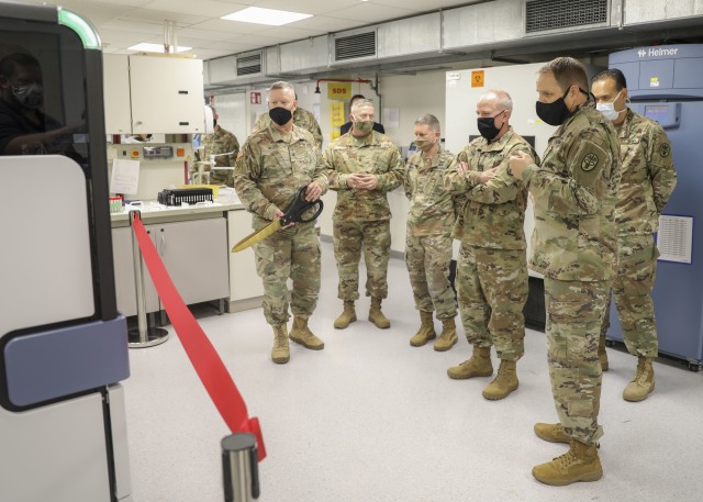 Brig. Gen. Mark Thompson (center), commanding general, Regional Health Command Europe, is introduced to Landstuhl Regional Medical Center’s first high-throughput testing system for COVID-19, July 8.
