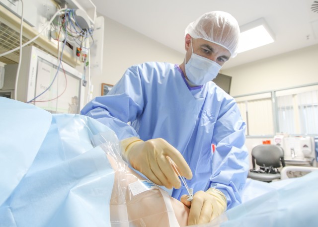 U.S. Air Force Capt. Arik Carlson, critical care nurse at Landstuhl Regional Medical Center, practices a Peripherally Inserted Central Catheter on a simulated patient, July 30. The PICC, as it is commonly referred to, are used for long-term intravenous treatments, a new capability at LRMC.