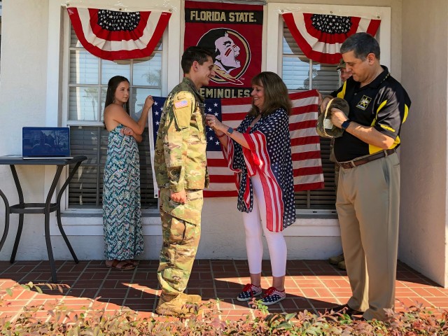 U.S. Army Reserve 2nd Lt. Curtis Rahman has his rank pinned on by his mom, Robin during his virtual commissioning ceremony held at his parent's home in Florida, May 2, 2020. 2nd Lt. Rahman is a cyber officer with the Army Reserve Cyber Operations...