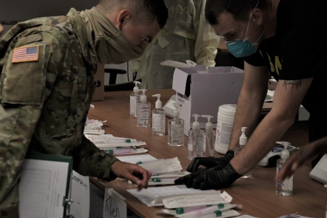 Medical Soldiers from the 7th Army Training Command, United States Army Garrison Bavaria, provide COVID 19 screening to U.S. Army Reserve Soldiers of the 7th Mission Support Command during in-processing for exercise Forward and Ready 20 at USAG...