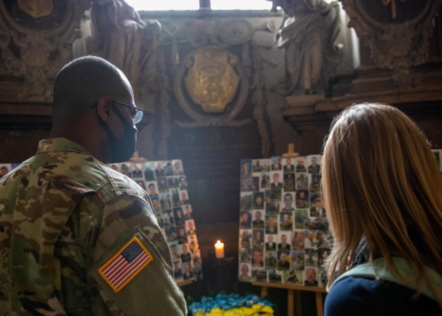 Task Force Illini Chaplain, (Maj.) Vincent Lambert examines a shrine dedicated to fallen Armed Forces Ukraine soldiers during a tour of Garrison Church in Lviv, Ukraine, Aug. 5. (Photos by Army Cpl. Shaylin Quaid, JMTG-U Public Affairs)
