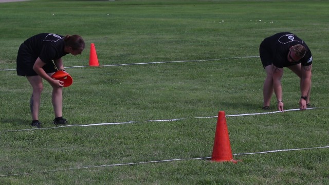 Sgt. Janina Felka-Burns, right, and Staff Sgt. Bronson Shipman, left, both master fitness trainers for the Kansas Army National Guard, show students with 1st Battalion, 161st Field Artillery Regiment, 130th Field Artillery Brigade how to set up Army Combat Fitness Test Lanes. Students took part in a two-day training to become validated ACFT graders Aug. 4-5 in Salina, Kansas.