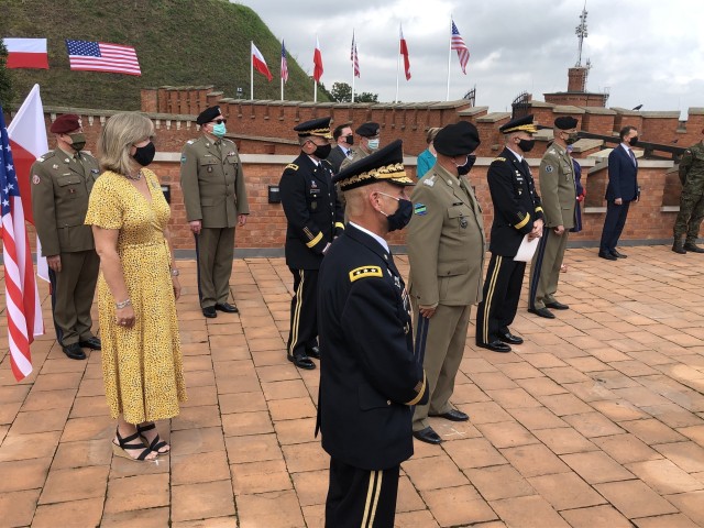 U.S. Army Europe commanding general, Lt. Gen Christopher Cavoli, observes U.S. Army Chief of Staff Gen. James C. McConville and Lt. Gen. John Kolasheskis, V Corps commanding general, officially unfurl the V Corps flag in Krakow, Poland, Aug. 4....
