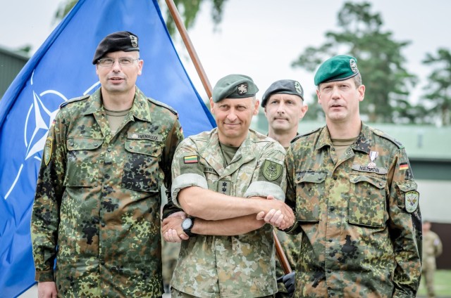 German Lt. Col. Peer Papenbroock, commander, 104th Panzer Battalion; Lithuanian Army Col. Mindaugas Petkevičius, commander, Iron Wolf Brigade; and German Lt. Col. Alex Niemann, commander, 371st Mechanized Infantry Battalion shake hands during the Transfer of Authority Ceremony on Aug. 4 at Rukla Barracks, Lithuania