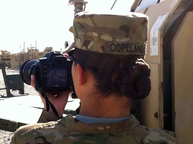 U.S. Army Staff Sgt. Rachel Copeland photographing events in Afghanistan during her 2014 deployment with the 982nd Combat Camera Company.