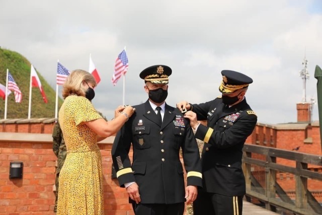 U.S. Army Chief of Staff Gen. James C. McConville pins on Lt. Gen. John Kolasheskis’ new rank during his promotion ceremony in Krakow, Poland, Aug. 4. Kolasheski is the new V Corps commanding general. The two went on to unfurl the V Corps flag, officially establishing the V Corps Headquarters (Forward).