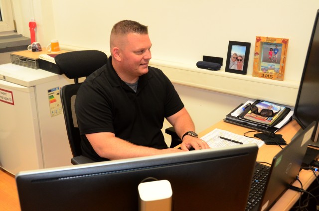 Sgt. 1st Class Chad Bailey, U.S. Army Garrison Rheinland-Pfalz Directorate of Emergency Services, works on an investigation report. Bailey helped save a driver's life during a recent weekend trip.