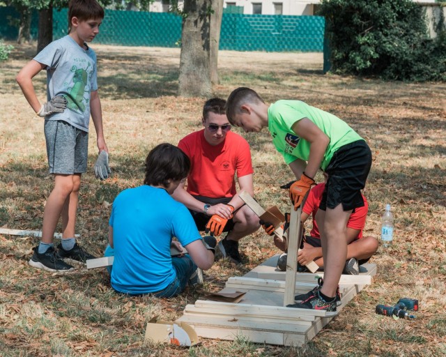 WIESBADEN, Germany - Tyler Houk (in the red shirt) works with volunteer scouts to build the platform component of the project at the dog park on Clay Kaserne Aug. 12, 2020.