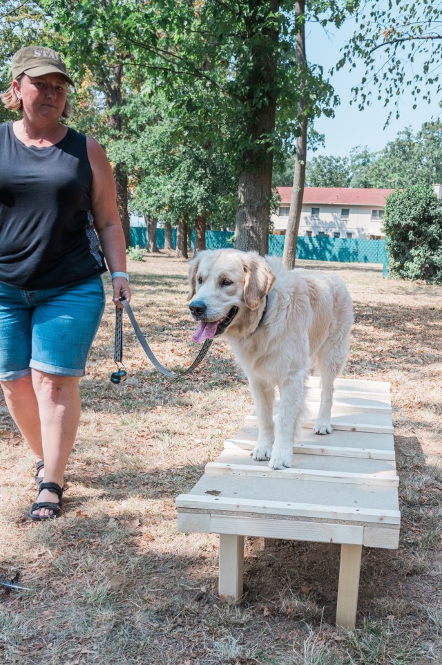 WIESBADEN, Germany – Jennifer Fligor encourages her dog, Beau, to stand and stop on the platform portion of the newly completed agility obstacles at the dog park on Clay Kaserne Aug, 12, 2020.