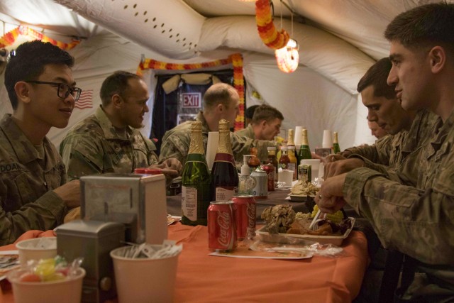 U.S. Army Soldiers assigned to Task Force-Southeast, located in Southeastern Afghanistan, enjoy a traditional Thanksgiving meal at a dining facility at a forward operating base, Nov. 28, 2019. UK Army Brigadier Leigh R. Tingey, Commanding General,...