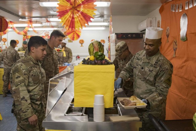 U.S. Army Lt. Col. Lafran Marks, Deputy Commander for Task Force-Southeast, serves Thanksgiving meals to U.S. Soldiers assigned to Task Force-Southeast, Nov. 28, 2019. The practice of senior leaders serving holiday meals to Soldiers is a long-standing military tradition during the Thanksgiving holiday. Task Force-Southeast is a subordinate command in support of Operation Freedom's Sentinel and Resolute Support, to train, advise, and assist Afghan National Defense Security Forces. (U.S. Army photo by Sgt. Nicholas Brown-Bell)