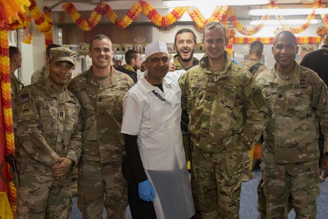 Task Force-Southeast Soldiers pose for a picture following Thanksgiving meals being served at Task Force headquarters in Southeastern Afghanistan, November 28, 2019. Task Force-Southeast Soldiers serve at three different locations and leadership flew to all three throughout the day. The practice of senior leaders serving holiday meals to Soldiers is a long-standing military tradition. Task Force-Southeast supports Operations FREEDOM'S SENTINEL and RESOLUTE SUPPORT, which provide invaluable training, advising, and assisting support to counterparts throughout Afghanistan. (US Army photo by Sgt. Nicholas Brown-Bell)