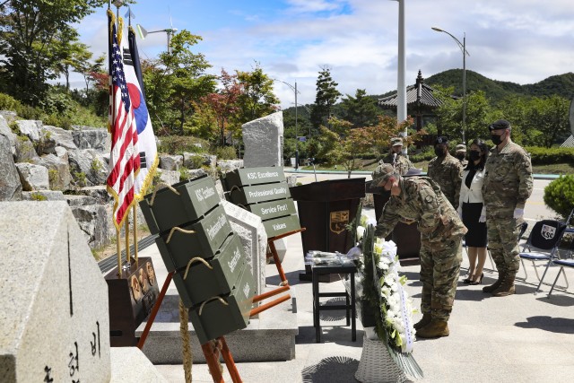 Mr. Yi, Chin U, Korean Service Corps Battalion deputy commander, lays a white flower of remembrance in front  of the KSC Korean War Memorial during a 70th Anniversary commemoration ceremony in Inje, South Korean, July 26, 2020. (U.S. Photo by Staff Sgt. Jacob Kohrs)