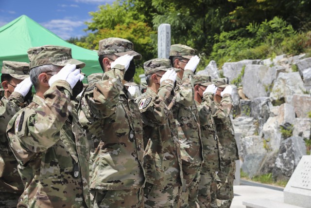 Korean Service Corps' company commanders salute the flags of the United States and the Republic of Korea during the playing of each countries national anthem at the KSC Korean War Memorial during a 70th Anniversary commemoration ceremony in Inje, South Korean, July 26, 2020. (U.S. Photo by Staff Sgt. Jacob Kohrs)