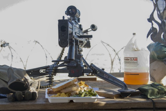 A Thanksgiving meal is placed next to a crew-served automatic weapon at a forward operating base located in Southeastern Afghanistan, Nov. 28, 2019. U.S. Soldiers are currently deployed across Southeastern Afghanistan supporting Afghan National Defense Security Forces . Several Soldiers at this forward base had their meals delivered to them due to the fact that they could not leave their battle positions. U.S. servicemembers are deployed in support of Operation Freedom'S Sentinel and Resolute Support to train, advise, and assist their Afghan partners. 
(U.S. Army photo by Sgt. Nicholas Brown-Bell)