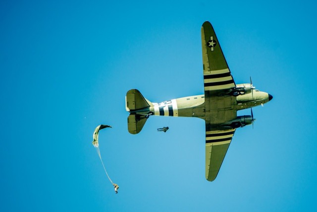 
FORT BENNING, Ga. –  A World War II-vintage C-47 transport plane makes an airdrop over Fort Benning&#39;s Fryar Drop Zone Aug. 16, 2019, in observance on National Airborne Day. Making the jump were historical re-enactors in World War II paratrooper uniforms. Fort Benning is birthplace of the U.S. Army Airborne, and home to the U.S. Army Airborne School, which trains paratroopers for the Army and other services. President George W. Bush established National Airborne Day in 2001 to commemorate a series of test parachute jumps that were completed Aug. 16, 1940 by the U.S. Army Parachute Test Platoon, leading to formation of the Army&#39;s Airborne units that fought in World War II. It is observed every Aug. 16.

(U.S. Army photo by Patrick A. Albright, Maneuver Center of Excellence and Fort Benning Public Affairs Office)
