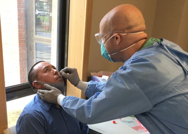 A medical professional from the 65th Medical Brigade conducts a nasal swab on an Eighth Army civilian employee who was randomly selected for Eighth Army COVID-19 Surveillance Testing Aug. 6 on Camp Humphreys, South Korea. (U.S. Army photo)