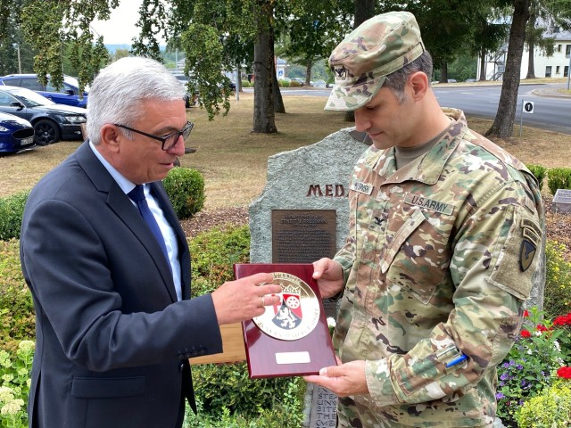 Rheinland-Pfalz Minister of the Interior Roger Lewentz explains the meaning of his state's crest to Col. Vance J. Klosinski, U.S. Army Garrison Rheinland-Pfalz commander, during a visit to Baumholder Military Community Aug. 13.