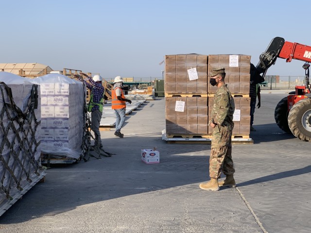 In response to the tragedy in Lebanon, 1st. Lt. Morgan Kim, distribution integration branch operations officer, 1st Theater Sustainment Command, ensures supplies are ready for transport at Camp Arifjan, Kuwait, Aug. 5, 2020. In less than 24 hours, the 1st TSC packaged and shipped more than 21,000 cases of culturally appropriate meals, 5,700 cases of bottled water, 670 cases of health and comfort packs, and three pallets of medical supplies.