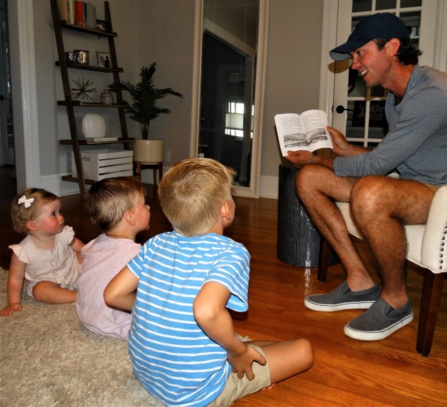 Madeline 1, William, 3, and Samuel, 5, listen to their father, Samuel P. Fortsch, read one of his books in the “Pawtriot Dogs” series, set to be released by Penguin Random House in September and October. (Contributed Photo)
