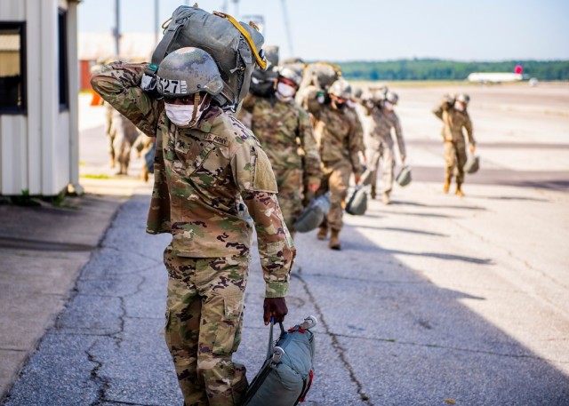 
FORT BENNING, Ga. –  In an April 2020 photo, students at the U.S. Army Airborne School here who hope to become paratroopers carry their parachutes to a packing shed at Lawson Army Airfield on Fort Benning. They wear masks as a precaution against spread of COVID-19. Fort Benning is birthplace of the U.S. Army Airborne, and home to the U.S. Army Airborne School, which trains paratroopers for the Army and other services. President George W. Bush established National Airborne Day in 2001 to commemorate a series of test parachute jumps that were completed Aug. 16, 1940 by the U.S. Army Parachute Test Platoon, leading to formation of the Army&#39;s Airborne units that fought in World War II. It is observed every Aug. 16.

(U.S. Army photo by Patrick A. Albright, Maneuver Center of Excellence and Fort Benning Public Affairs Office)
