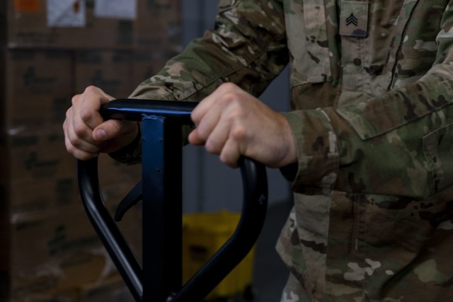 Soldiers from the Connecticut Army National Guard load a truck to deliver Covid-19 testing kits from the Governor William A. O'Neill State Armory to a storage facility in Hartford, Conn., Aug. 14, 2020. The testing kits are being stored in the...